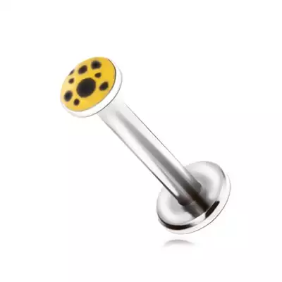 Piercing állba acélból, fekete foltok sárga alapon